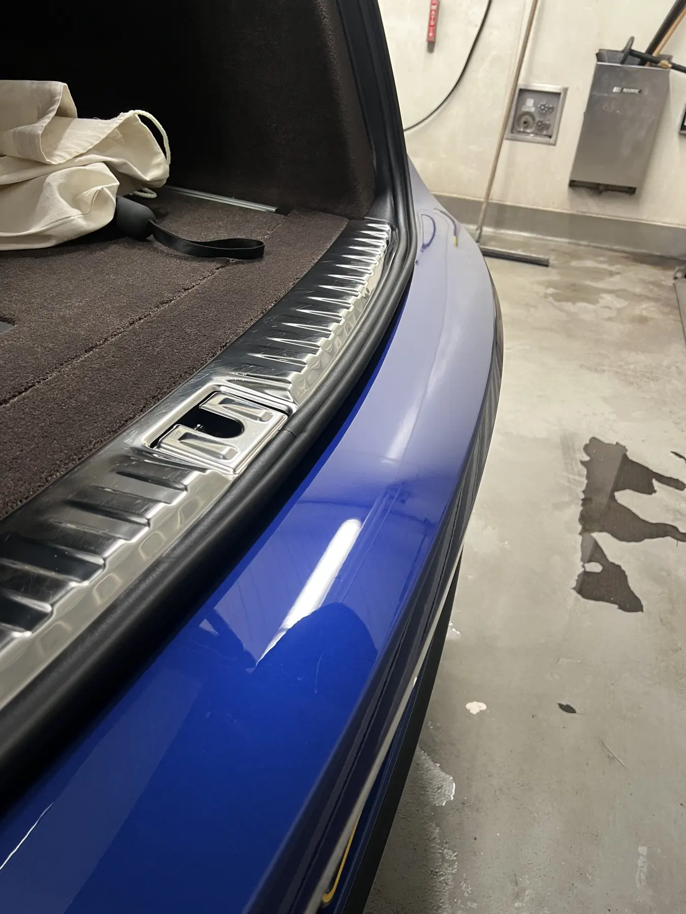 Blue painted bumper after scratch correction