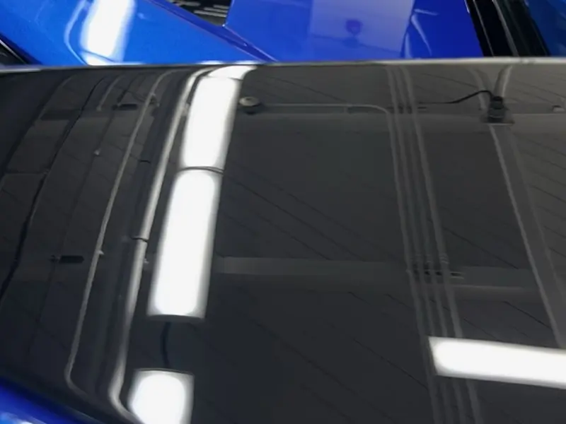 Black engine panel after paint correction
