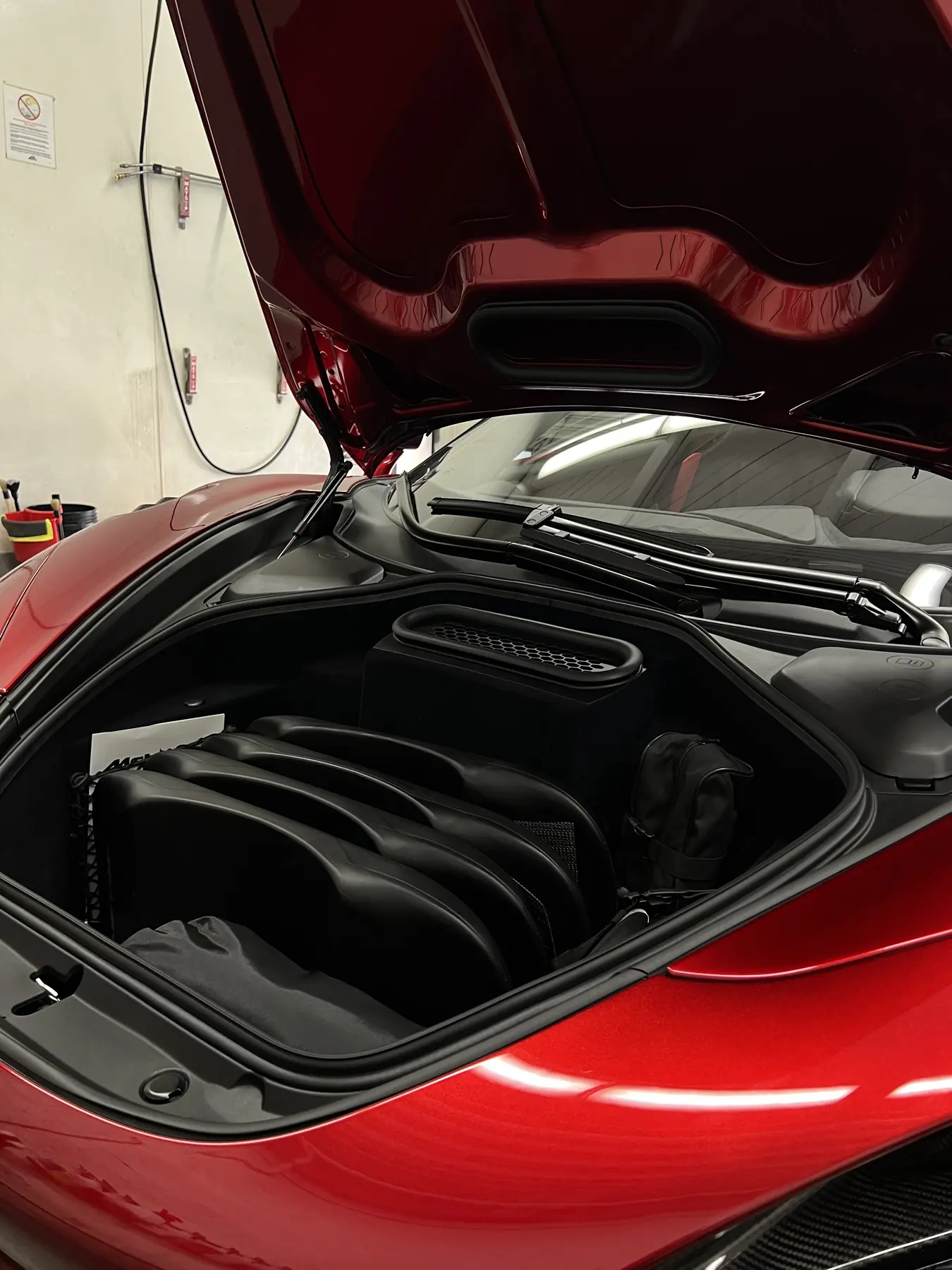 Clean front compartment of a red McLaren