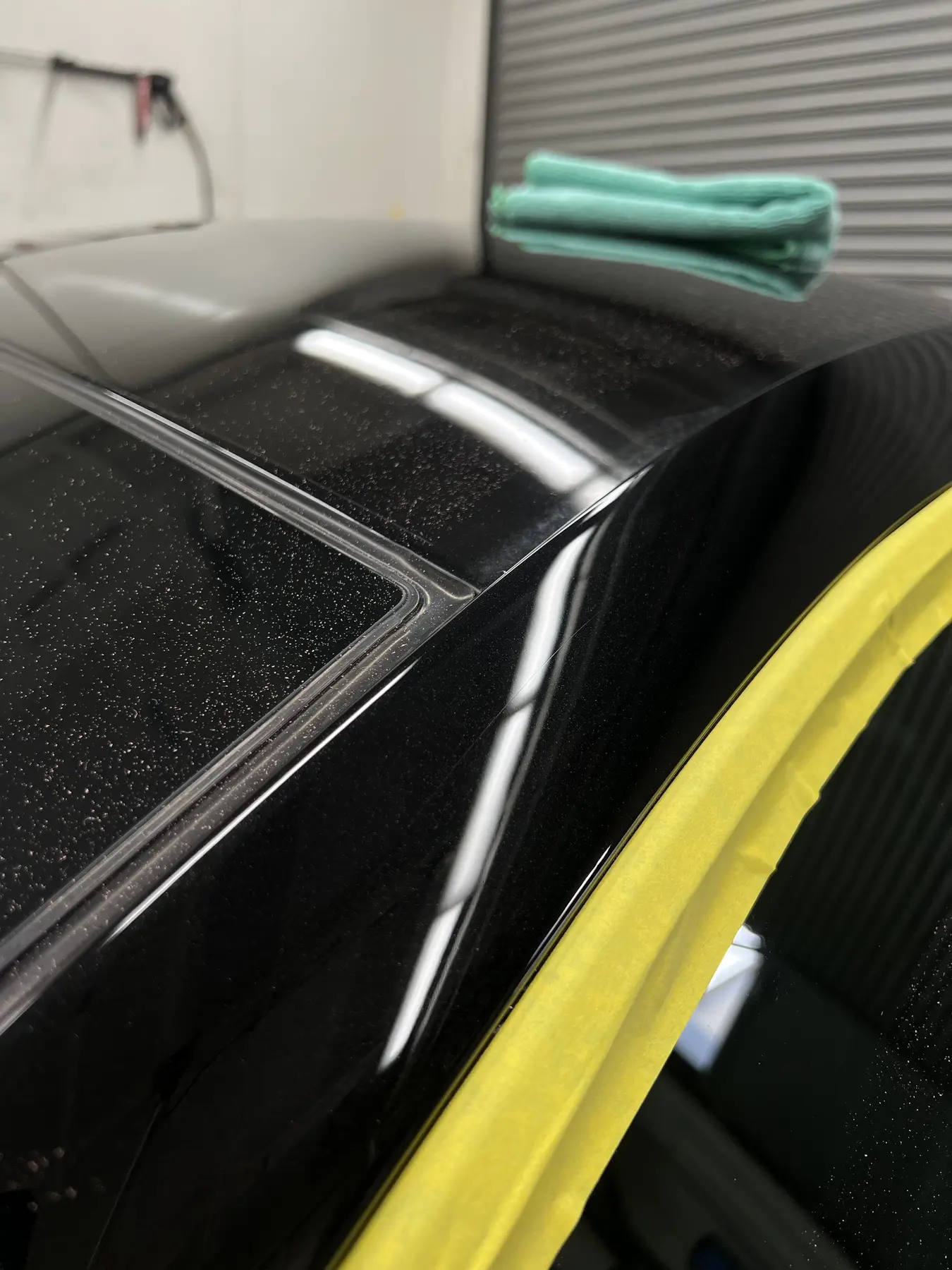 Black roof panel before paint correction